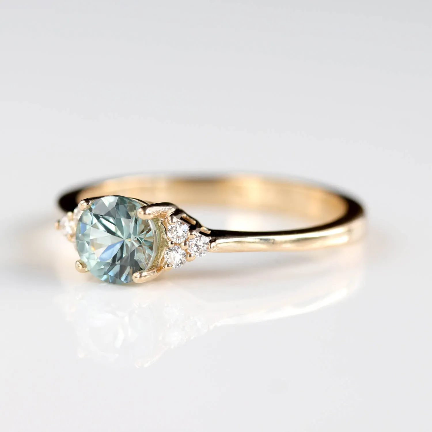 Seven Stone Basket Cluster Engagement Ring with a 5mm Malawi Sapphire